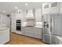 Modern kitchen with white cabinetry, stainless steel appliances, and granite countertops offers a luxurious feel at 3994 Limerick Dr, Burlington, NC 27215