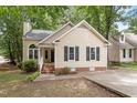 Charming one-story home with a welcoming front porch, landscaped yard, and a well-maintained exterior at 4401 Liverpool Ln, Raleigh, NC 27604