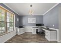 Well-lit home office with modern desk setup, custom cabinetry, and large window for natural light at 507 Littleport Dr, Rolesville, NC 27571