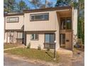 Charming townhouse exterior with a covered entryway, multiple windows, and simple landscaping at 5073 Tall Pines Ct, Raleigh, NC 27609