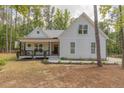 Charming exterior view of a two-story home with manicured landscaping and inviting front porch at 5163 S River Rd, Lillington, NC 27546