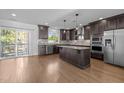 Spacious kitchen featuring granite countertops, stainless steel appliances, a center island, and hardwood floors at 531 N Person St # 205, Raleigh, NC 27604