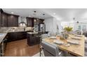 Stylish kitchen features an island, stainless steel appliances, wood floors and a dining area at 531 N Person St # 205, Raleigh, NC 27604