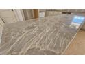 Close-up shot highlighting the gray, swirling pattern in the beautiful granite kitchen island counter at 55 Stream View Way, Spring Hope, NC 27882