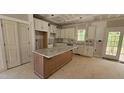 Bright kitchen with island, granite counters, custom cabinets, and stainless sink at 55 Stream View Way, Spring Hope, NC 27882