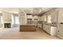 Bright kitchen with island, granite counters, custom cabinets, and stainless sink at 55 Stream View Way, Spring Hope, NC 27882