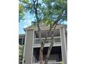 Close up of the building balcony with a tree, and a glimpse of furnishings at 631 Springfork Dr, Cary, NC 27513