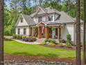 Beautiful home showcasing a covered front porch with wood columns and well-maintained landscaping at 67 Spring Hollow Ct, Pittsboro, NC 27312