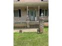 Home entrance with a patterned glass front door, brick posts, and iron railings at 836 S Main St, Roxboro, NC 27573