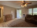 Open living room with neutral walls, patterned rug, and a view towards the entrance at 8405 Falcon Crest Cir, Angier, NC 27501