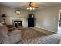 Living room with fireplace, classic rug, and comfortable seating for relaxing at home at 8405 Falcon Crest Cir, Angier, NC 27501