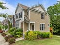 Well-maintained townhouse with brick and siding exterior, complemented by beautiful landscaping and shrubbery at 100 Stratford Lakes Dr # 270, Durham, NC 27713