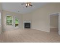 Bright living room with a fireplace, wood-look floors and access to the back deck at 1020 Kingston Grove Dr, Cary, NC 27519