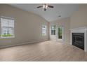 The living room offers wood-look floors, a fireplace, and a ceiling fan at 1020 Kingston Grove Dr, Cary, NC 27519