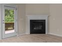 Close up of the living room fireplace and access to the back deck at 1020 Kingston Grove Dr, Cary, NC 27519