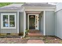 Welcoming front entrance features a decorative door and brick walkway at 103 Lakeway Ct, Cary, NC 27511