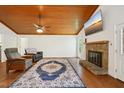 A cozy living room featuring a fireplace, hardwood floors, and a TV at 103 Lakeway Ct, Cary, NC 27511