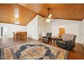 Spacious living room and dining room area with hardwood floors, ceiling fan, and multiple chairs at 103 Lakeway Ct, Cary, NC 27511