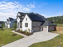 Beautiful home with a two car garage, solar panels and a long concrete driveway at 105 Scotland Dr, Youngsville, NC 27596
