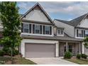 Charming two-story townhome with a well-manicured lawn and a two-car garage at 107 Explorer Dr, Morrisville, NC 27560