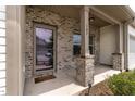 Inviting front porch with brick pillars, house number 107, and a stylish glass-paneled front door at 107 Explorer Dr, Morrisville, NC 27560