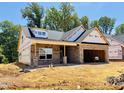 A brick exterior with an attached garage is under construction, set against a backdrop of green trees and blue sky at 1087 Fairhaven Dr # 48, Mebane, NC 27302