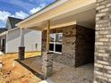 A lovely brick porch on a new construction house, supported by column posts, offers a welcoming entry at 1087 Fairhaven Dr # 48, Mebane, NC 27302