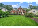 Lovely brick home with a well-manicured front lawn, mature landscaping, and a welcoming facade at 112 Sterling Ridge Way, Cary, NC 27519