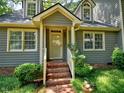 Inviting front entrance with brick steps, detailed trim and a well-maintained lawn at 119 Long Shadow Ln, Cary, NC 27518
