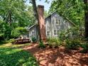 The rear and side of the home is surrounded by mature trees and shrubbery at 119 Long Shadow Ln, Cary, NC 27518