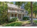 Charming two-story home with a covered front porch, landscaped yard, and a two-car garage at 124 Cypress View Way, Apex, NC 27502