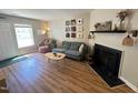 Charming living room featuring a cozy fireplace, comfortable seating, and inviting decor at 129 Friar Ln, Carrboro, NC 27510