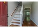 Welcoming entryway with hardwood floors and staircase leading to the upper level at 1310 Southgate Dr, Raleigh, NC 27610