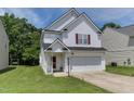 Charming two-story home with white siding, attached garage, and well-maintained lawn at 1310 Southgate Dr, Raleigh, NC 27610