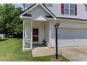 Inviting front porch with decorative lamp post and well-manicured lawn at 1310 Southgate Dr, Raleigh, NC 27610
