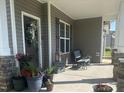 Cozy front porch with decorative plants and seating, inviting outdoor relaxation at 137 Campaign Dr, Mebane, NC 27302