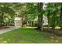 Beautiful single-story home on a grassy lot with mature trees and an inviting driveway at 154 Jared Dr, Fuquay Varina, NC 27526
