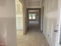 Unfinished hallway with neutral walls, leading to a room with view of backyard at 1613 Malcus Ct # 68, Fuquay Varina, NC 27526