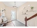 Welcoming entryway with a decorative front door, tiled flooring, and elegant chandelier lighting at 1717 Ormond Rd, Hurdle Mills, NC 27541