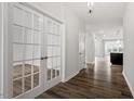 Entryway featuring hardwood floors, French doors to a study, and view of the kitchen at 219 Berry Mill Ln # 179, Raleigh, NC 27603
