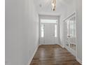 Inviting entryway with hardwood floors, white trim, and a view of the front door at 219 Berry Mill Ln # 179, Raleigh, NC 27603