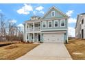 Beautiful two-story home with an attached two-car garage and a balcony over the front porch at 219 Berry Mill Ln # 179, Raleigh, NC 27603