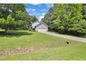 View of the house from a distance showing the lawn, garage, and part of the driveway at 2312 Brasswynd Ct, Fuquay Varina, NC 27526