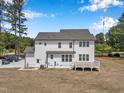 Backyard view showcasing the house's white siding and a wooden deck, offering an outdoor living space at 2371 Old Us 421, Lillington, NC 27546