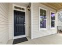 Inviting front door with sidelight and exterior light fixture at 25 Long Needle Ct # 37, Youngsville, NC 27596