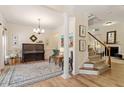 Elegant living room showcasing a piano, staircase, hardwood floors, and decorative furnishings at 300 Quarryrock Road Rd, Holly Springs, NC 27540