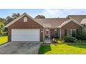 Charming brick home with a two-car garage, landscaped lawn, and inviting front porch at 3027 Maple Ave # U1, Burlington, NC 27215