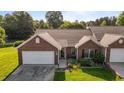 Well-maintained brick home with a two-car garage, landscaped lawn, and welcoming front entrance at 3027 Maple Ave # U1, Burlington, NC 27215