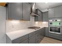 Modern kitchen with gray cabinets, stainless steel appliances, and a stylish backsplash at 33 Black Walnut Dr # 185, Garner, NC 27529
