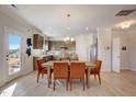Open-concept dining area featuring bright lighting, lovely flooring, and comfortable orange chairs at 334 Deodora Ln, Cameron, NC 28326